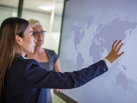 Employees looking at world map